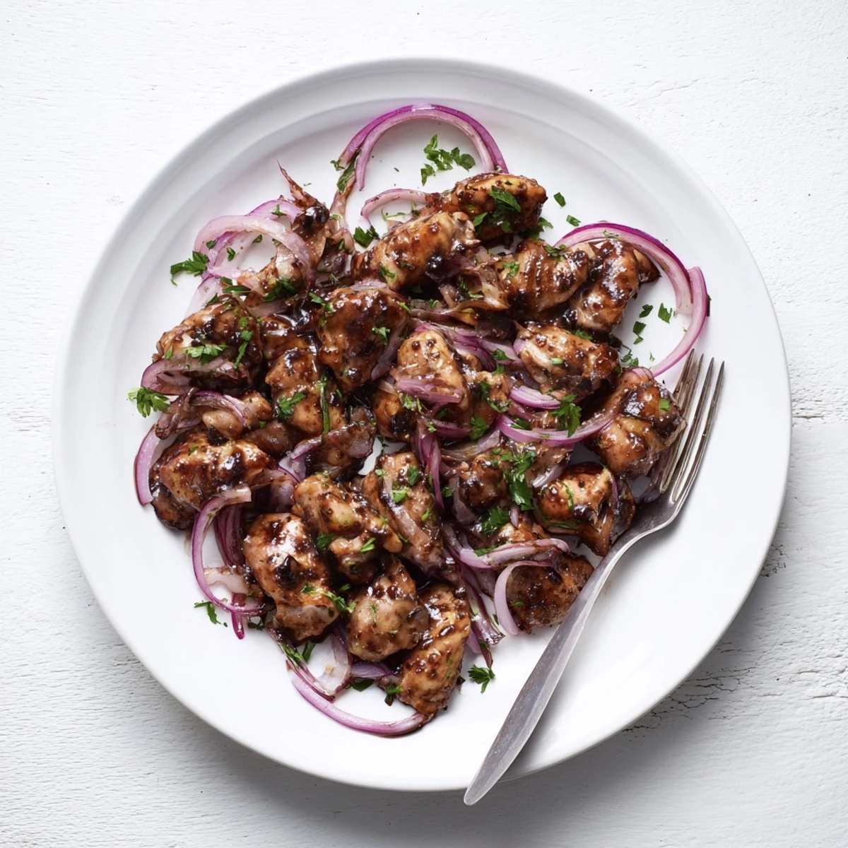 Succulent slow cooker balsamic chicken served over creamy mashed potatoes with caramelized onions