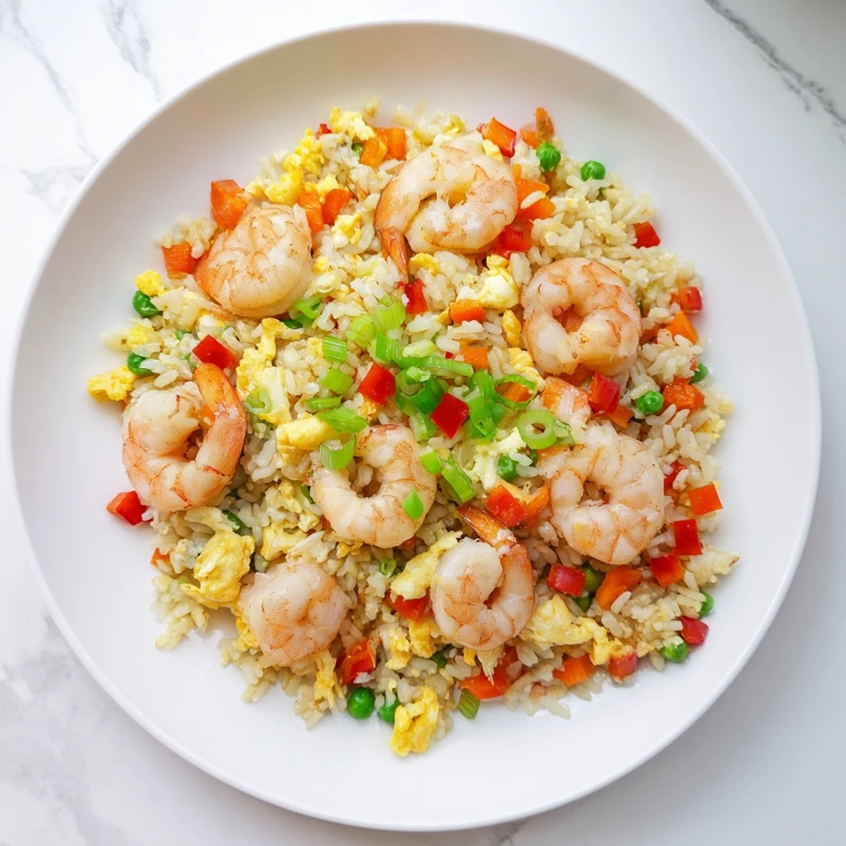 Close-up of succulent garlic prawns served over fragrant Asian sweet chilli fried rice