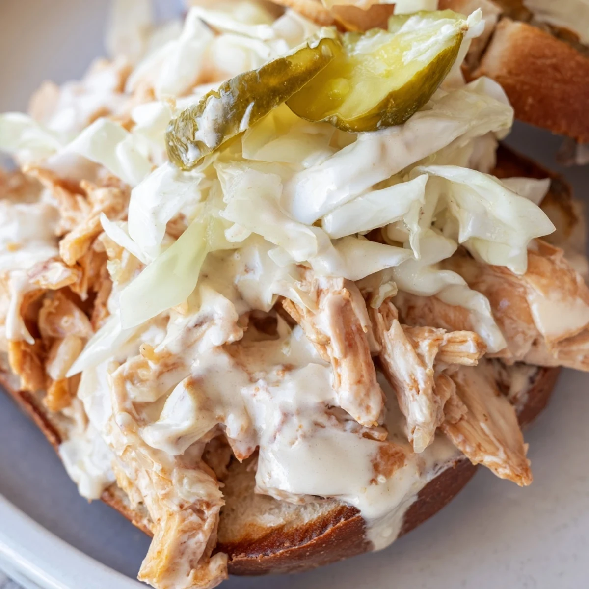 Alabama BBQ Chicken Chopped Sandwich featuring saucy smoked chicken piled on toasted buns with crisp slaw
