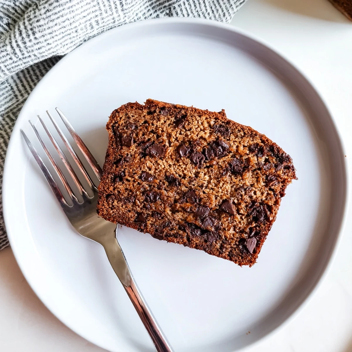 Moist slice of chocolate espresso banana bread revealing dark chocolate pockets and tender banana crumb interior