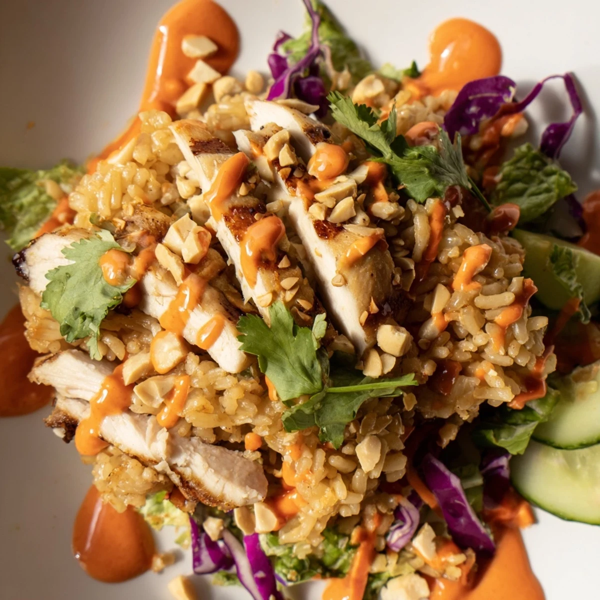 Tender sliced chicken and crunchy vegetables top this colorful Bang Bang Chicken crispy rice salad