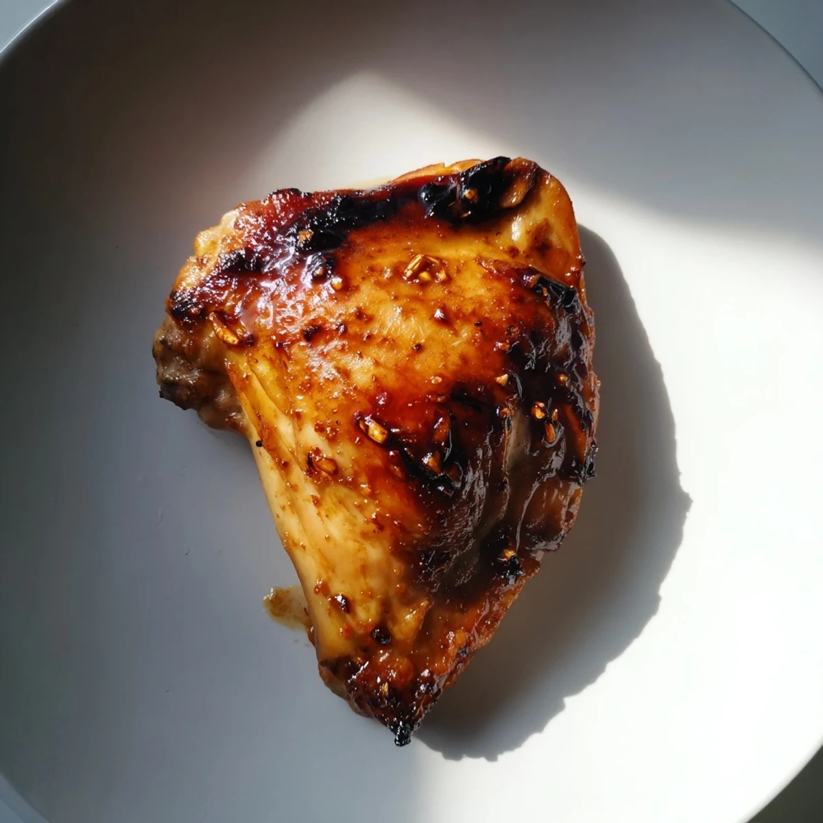 Crispy golden potatoes and fragrant herb rice plated beside sticky glazed chicken thighs fresh from oven
