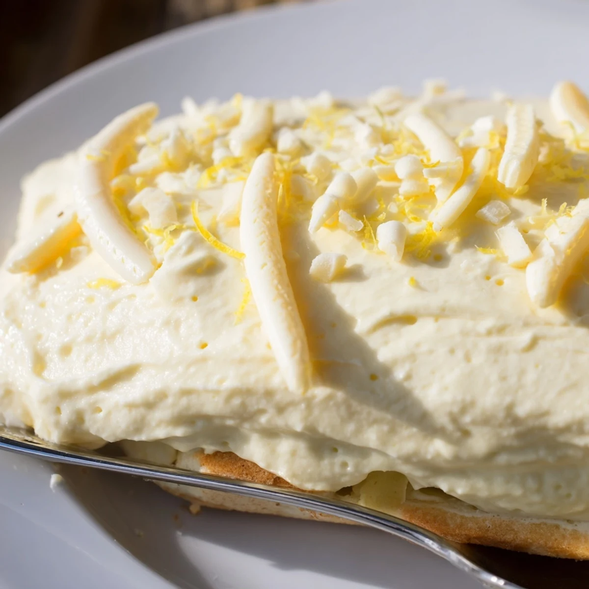 Creamy no bake lemon tiramisu sliced in a glass dish with mint