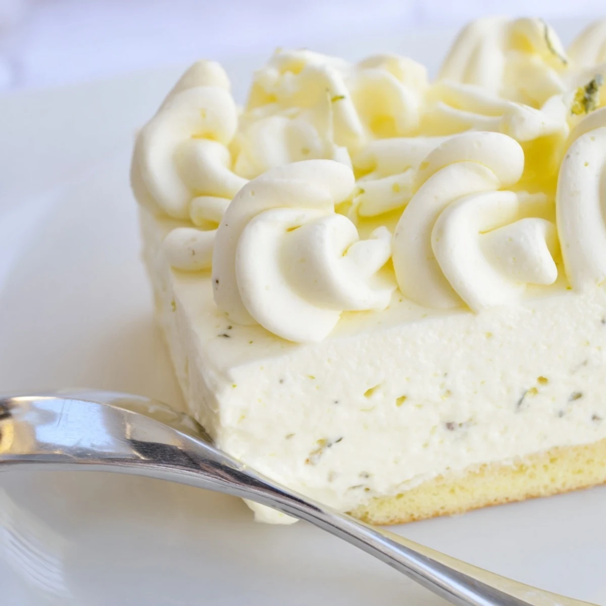 Layers of lemon tiramisu topped with bright zest and white chocolate curls