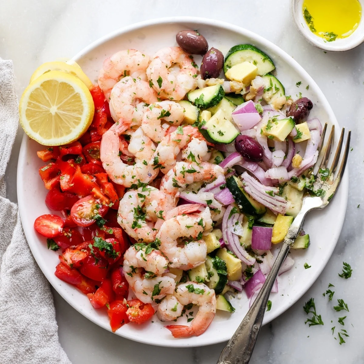 One-pan Mediterranean shrimp skillet simmered with zucchini, bell peppers, and lemon wedges.