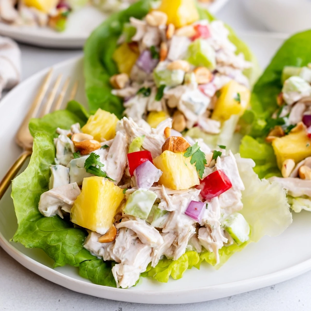 Bright Hawaiian Chicken Salad Recipe served on butter lettuce, crunchy macadamias, chilled.