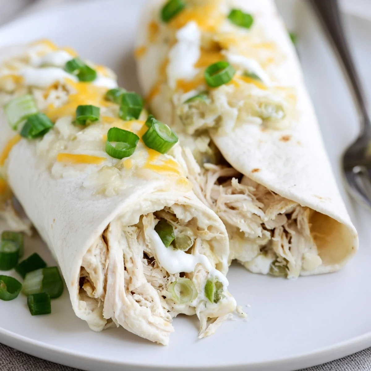 Cheesy White Rotisserie Chicken Enchiladas topped with cilantro, ready to serve.