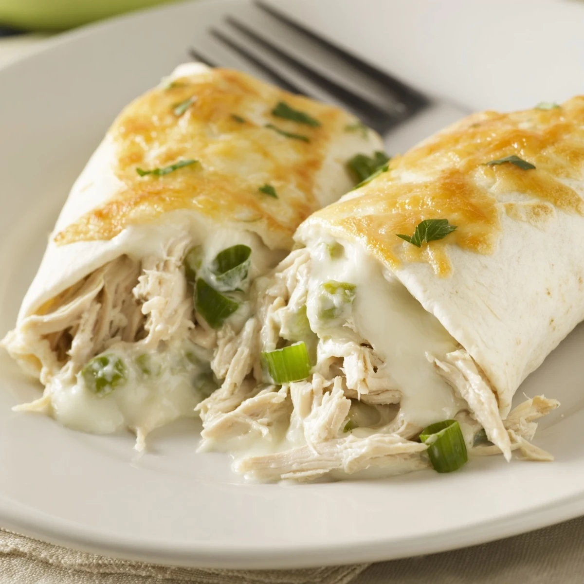 Oven-baked White Rotisserie Chicken Enchiladas sliced, steaming, served with rice.