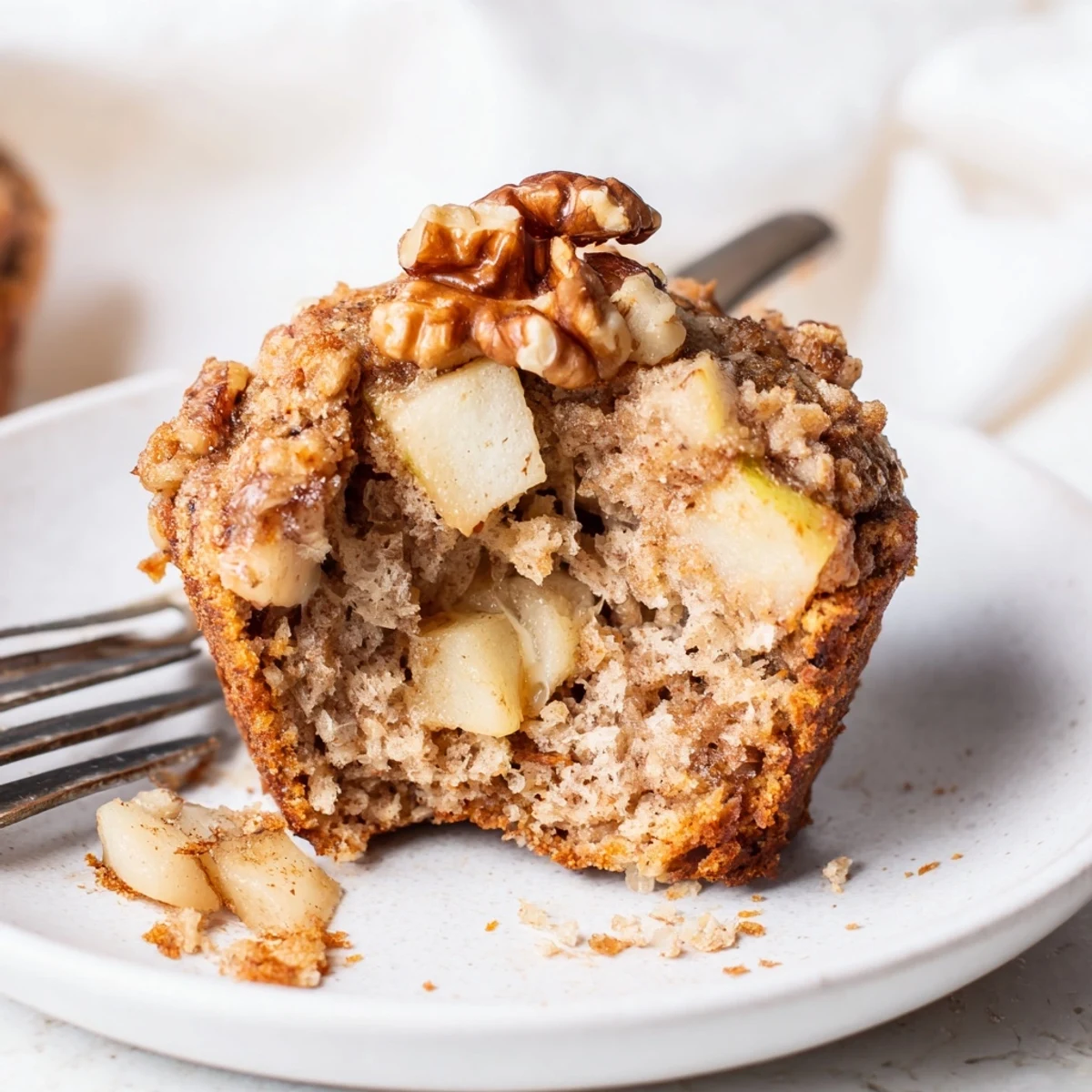 Healthy Apple Cinnamon Greek Yogurt Muffins sliced to show juicy apple pieces, soft interior
