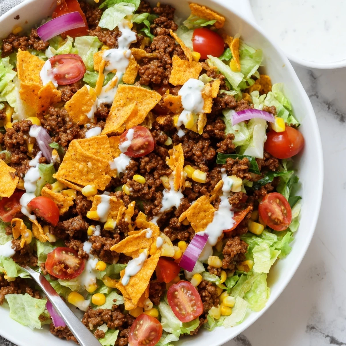 Tossed moments before serving, creamy ranch coats Simple Doritos Taco Salad