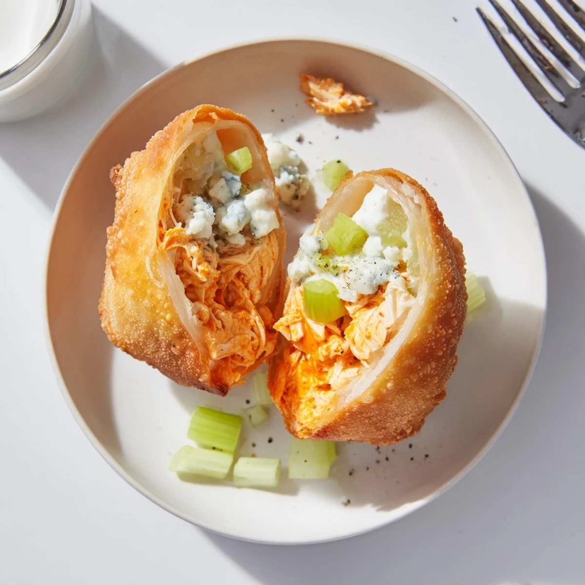 Golden-fried Buffalo Chicken Egg Rolls with celery crunch and blue cheese crumble.