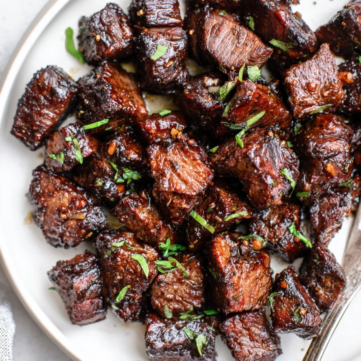 Plate of Sweet Spicy Jerk Style Beef Bites steaming, cilantro garnish, zesty aroma  