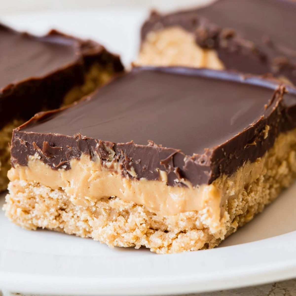 Rich peanut butter bars featuring smooth chocolate ganache and graham cracker base