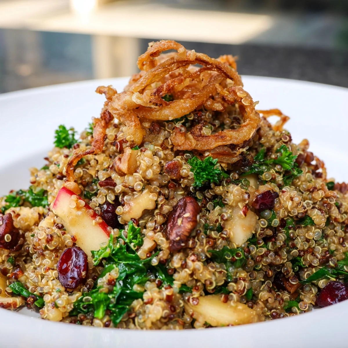 Honey Mustard Quinoa Apple Salad topped with golden crispy shallots in a white bowl